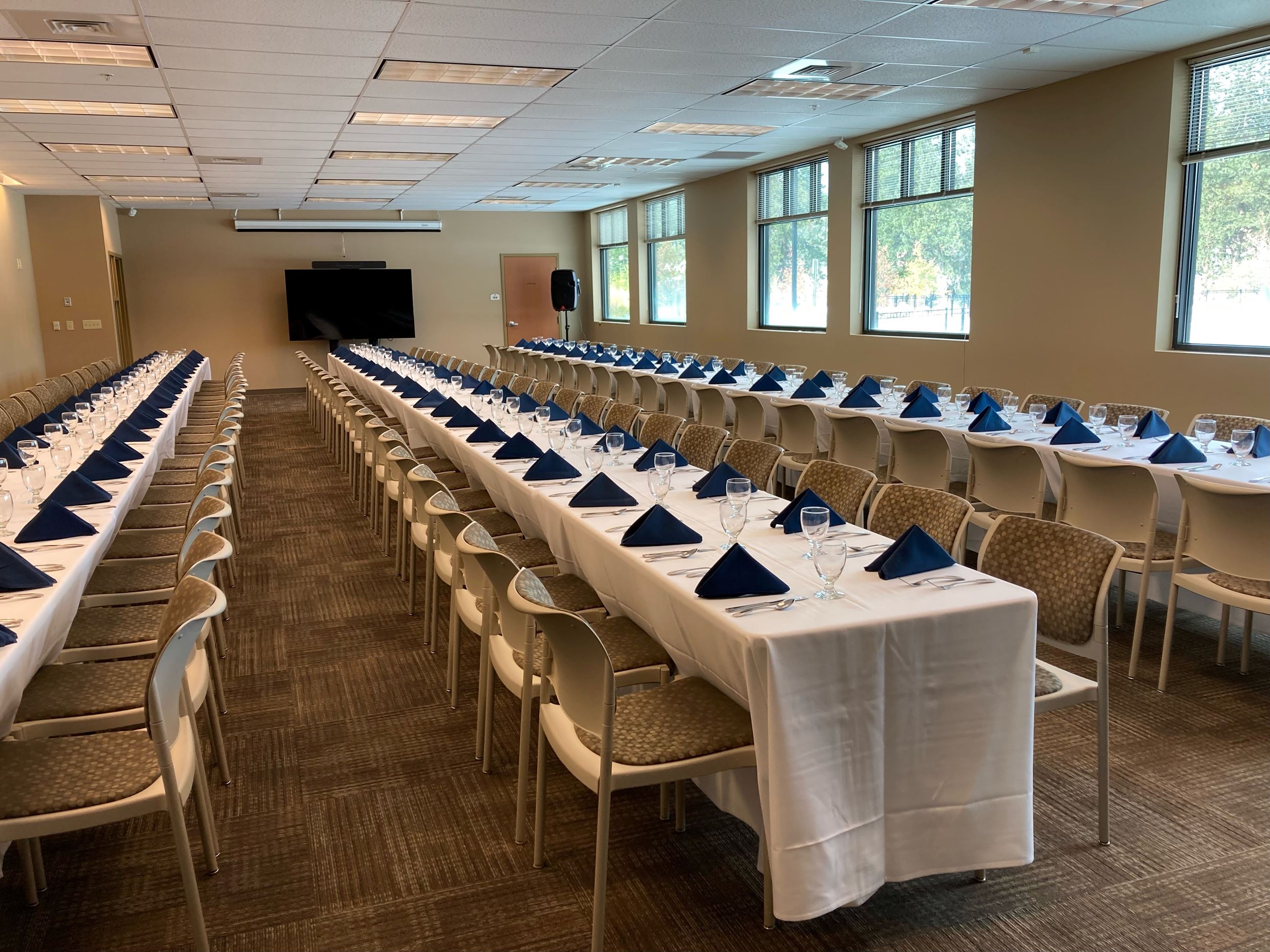 Long table seating in a large meeting room at CenterPlace