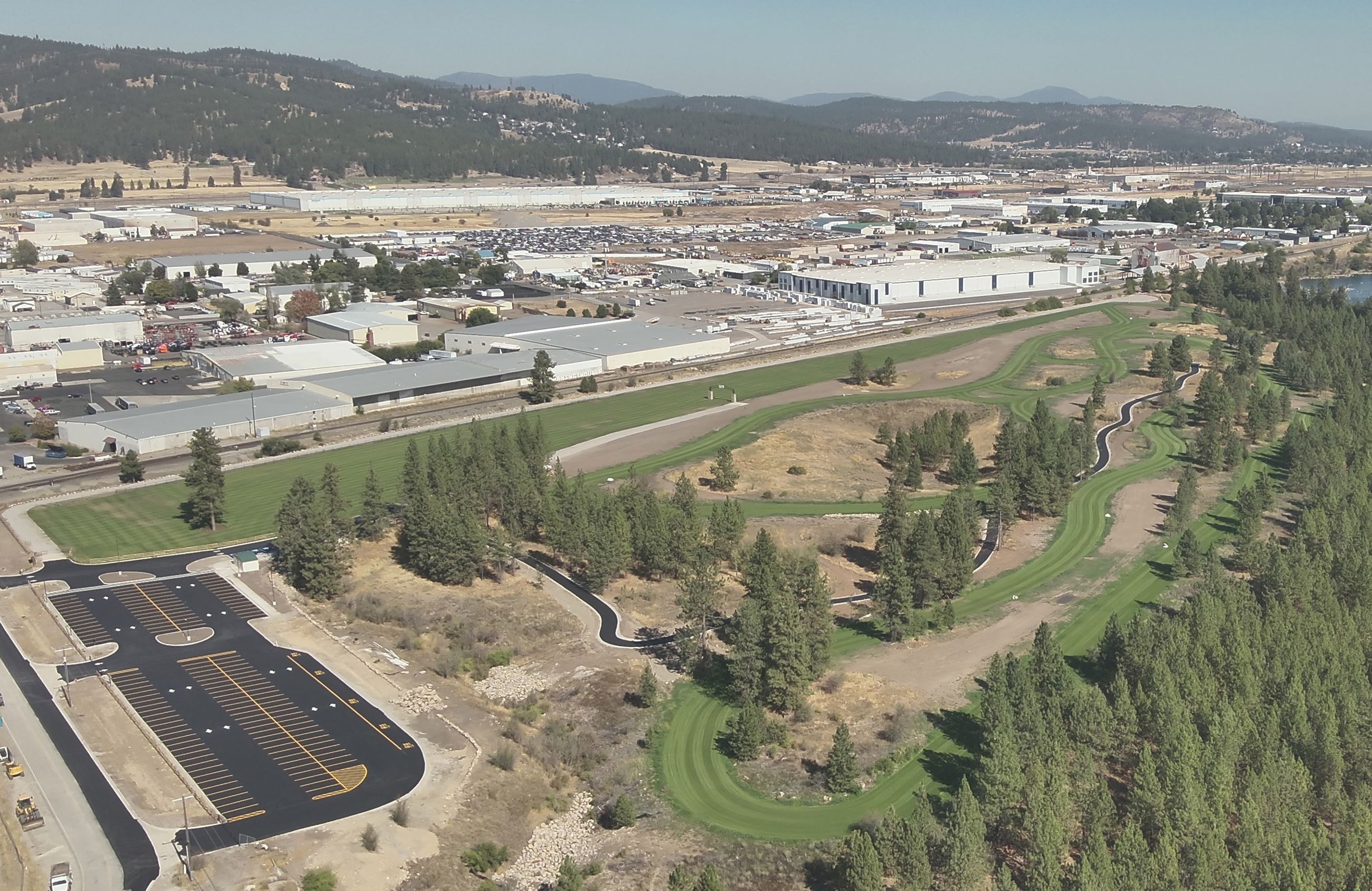 Aerial image of grass course and parking area.