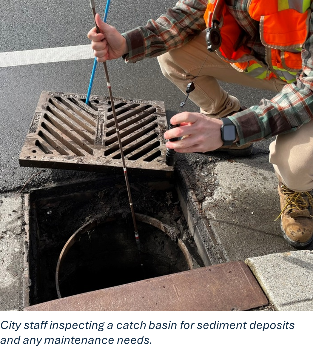 City staff inspecting a catch basin for sediment deposits and any maintenance needs.